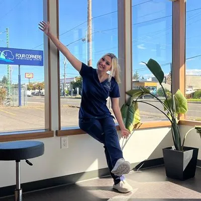 A Four Corners team member in the sunny front window of the new hospital